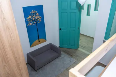 a room with a door and a tree on the wall at Loft Moderno junto al Monasterio de Jericó in Jericó