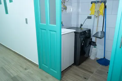 a green door in a kitchen with a washing machine at Loft Moderno junto al Monasterio de Jericó in Jericó