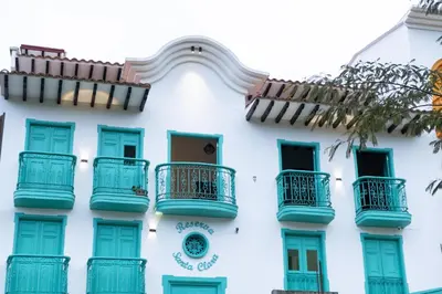 a white building with blue balconies on it at Loft Moderno junto al Monasterio de Jericó in Jericó