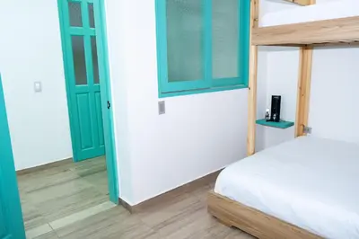 a bedroom with a bunk bed and blue doors at Loft Moderno junto al Monasterio de Jericó in Jericó