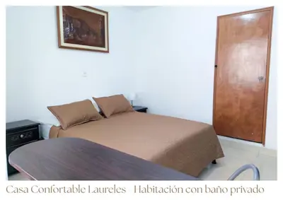 a bedroom with a bed and a wooden door at Casas confortable Laureles in Medellín