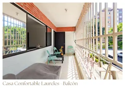 a living room with a couch and some windows at Casas confortable Laureles in Medellín