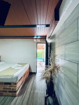 a bedroom with a bed and a wooden ceiling at Hotel Kapla in San Rafael