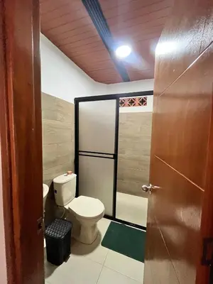 a bathroom with a toilet and a shower stall at Hotel Kapla in San Rafael