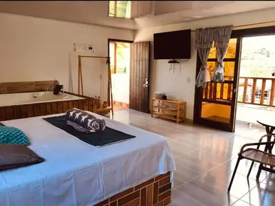 a bedroom with a bed and a television in it at Hotel Kapla in San Rafael