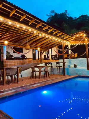 a patio with a table and chairs next to a swimming pool at Hotel Kapla in San Rafael