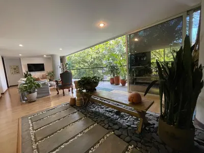 a living room with a bench and some plants at Modern & Calm Stay Near Provenza in Medellín