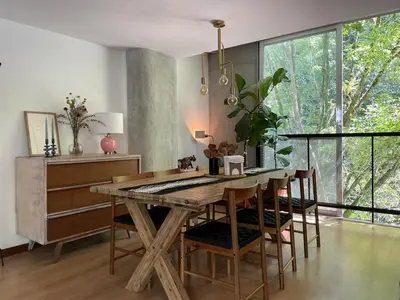 a dining room with a wooden table and chairs at Modern & Calm Stay Near Provenza in Medellín