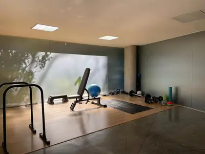 a gym with exercise equipment on a wooden floor at Modern & Calm Stay Near Provenza in Medellín