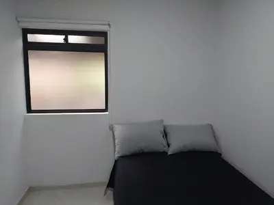 a small bedroom with a bed and a window at Single studio apartment 4 in Medellín