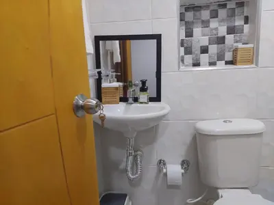 a bathroom with a sink and a toilet and a mirror at Single studio apartment 4 in Medellín