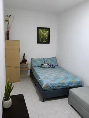 a bedroom with a bed in a room at individual studio apartment 3 in Medellín