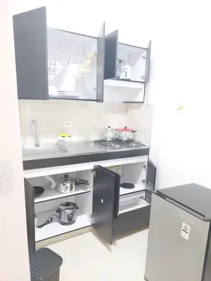 a kitchen with a sink and a refrigerator at individual studio apartment 3 in Medellín