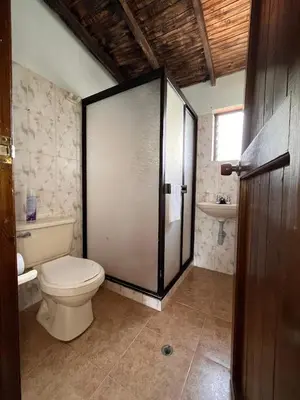 a bathroom with a toilet and a sink at Alojamiento Campestre La Villa Sanadora in Medellín