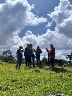 a group of people standing in a field flying a kite at Alojamiento Campestre La Villa Sanadora in Medellín