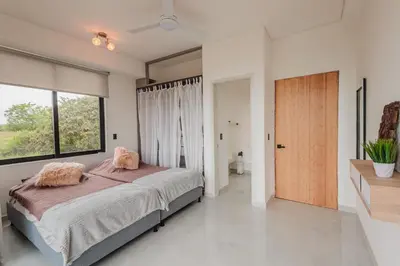 a bedroom with a bed and a large window at Luxury Villa in Cerritos ride horses nearby in Pereira