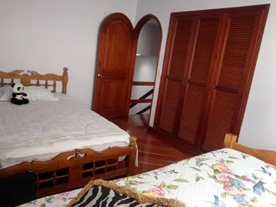 a bedroom with two beds and a bunk bed at Casa acogedora y excelente ubicación in Manizales