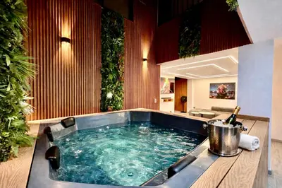 a jacuzzi tub in a room with plants at Exclusive house in the Malibu sector in Medellín