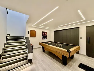a room with a pool table and some stairs at Exclusive house in the Malibu sector in Medellín