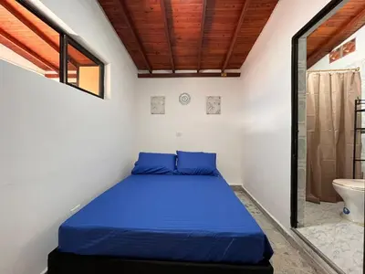 a bedroom with a blue bed in a bathroom at Apartment near downtown in Medellín