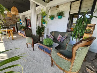 a living room with a couch and chairs and plants at hotel campestre cerca del aeropuerto vía autopista Medellín Bogotá in Rionegro