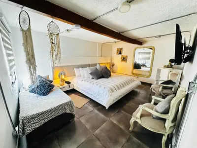 a bedroom with a bed and a chair in it at hotel campestre cerca del aeropuerto vía autopista Medellín Bogotá in Rionegro