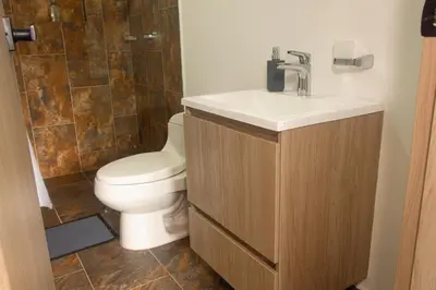 a bathroom with a toilet and a sink and a shower at Frente al mall Viva Envigado, AC, moderno in Envigado