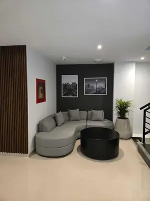 a living room with a couch and a table at Rooca Urban in Medellín