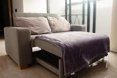 a bed with a purple blanket on top of it at Frente a Viva Envigado, AC, moderno e iluminado in Envigado