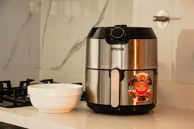 a coffee maker sitting on a counter next to a bowl at Frente a Viva Envigado, AC, moderno e iluminado in Envigado