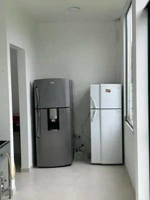 two refrigerators are sitting in a room at Finca Pacora in Palestina