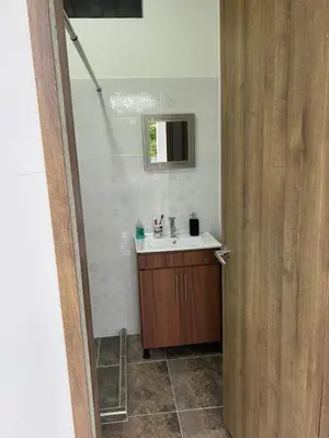 a bathroom with a sink and a mirror at Finca Pacora in Palestina