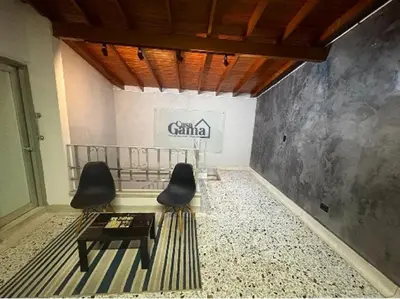 a room with two chairs and a table and a sign at CASA GAMA Your spring in Medellín in Medellín