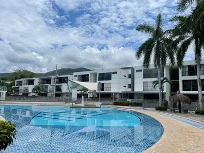 a swimming pool in front of a building at Apartasol santafe live in Santa Fe de Antioquia