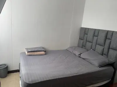 a bed in a room with a gray bed frame at Apartasol santafe live in Santa Fe de Antioquia