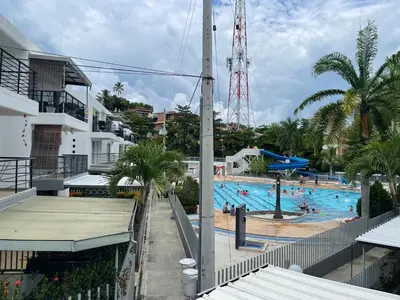 a large swimming pool with people in it at Apartasol santafe live in Santa Fe de Antioquia
