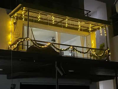 a balcony with christmas lights on a building at Apartasol santafe live in Santa Fe de Antioquia