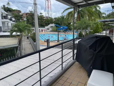 a view of a swimming pool from a balcony at Apartasol santafe live in Santa Fe de Antioquia