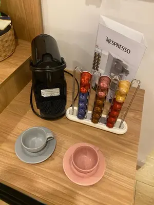 a coffee maker sitting on a counter next to a plate at Hotel Ryo 74b Piso 7 Vip in Medellín