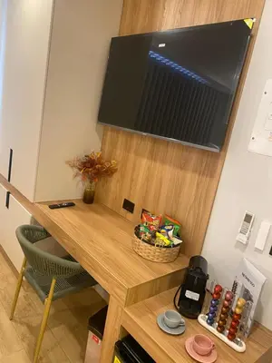 a room with a desk with a television on a wall at Hotel Ryo 74b Piso 7 Vip in Medellín