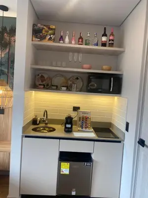 a kitchen with a sink and a microwave at Hotel Ryo 74b Piso 7 Vip in Medellín