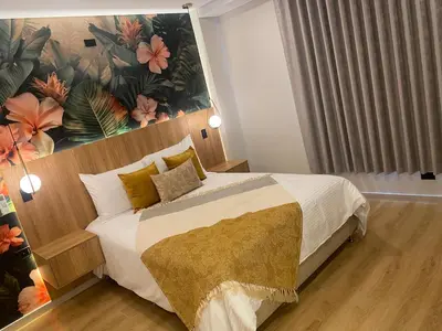 a bedroom with a large bed with a large painting on the wall at Hotel Ryo 74b Piso 7 Vip in Medellín