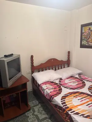 a bedroom with a bed and a small tv at Casa en Urrao Antioquía in Urrao