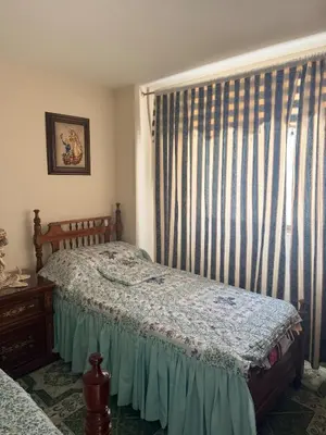 a bedroom with a bed and a window with curtains at Casa en Urrao Antioquía in Urrao