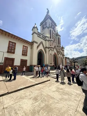 a group of people standing in front of a church at Casa en Urrao Antioquía in Urrao
