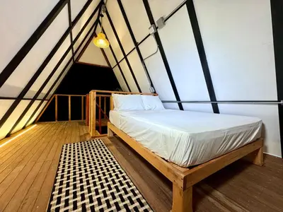 a bed in the middle of a room at Cabaña con jacuzzi en Venecia in Venecia