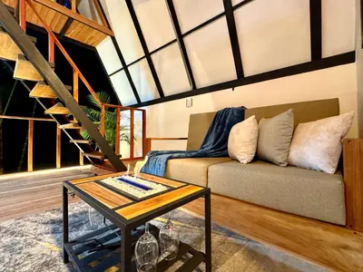 a living room with a couch and a table at Cabaña con jacuzzi en Venecia in Venecia
