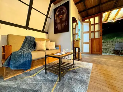 a living room with a couch and a table at Cabaña con jacuzzi en Venecia in Venecia