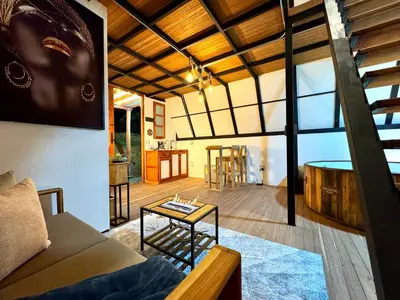 a living room with a couch and a table at Cabaña con jacuzzi en Venecia in Venecia