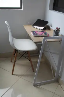 a desk with a chair and a laptop on it at Acogedor Apartamento en la ciudad de Medellín- La floresta in Medellín